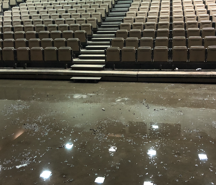stadium seating with standing water on the floor