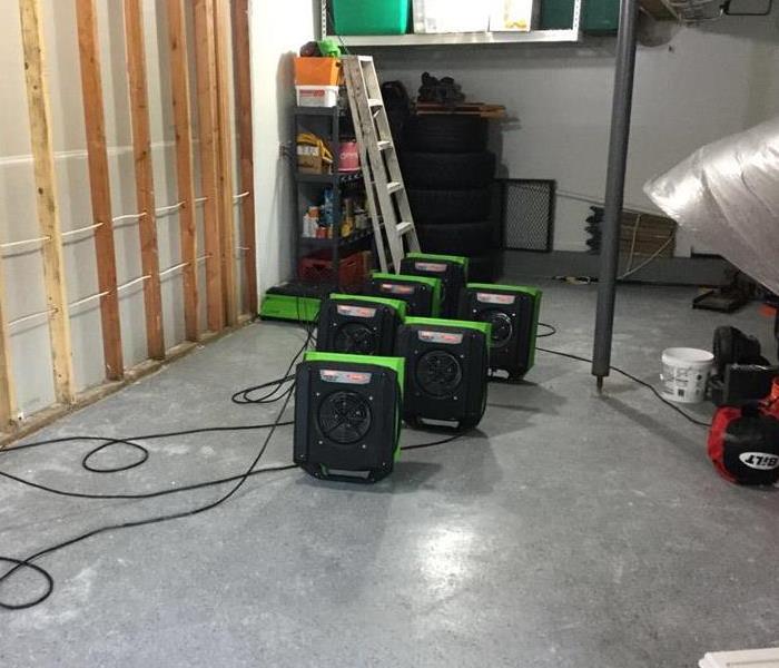 the interior of a building with air movers set up 