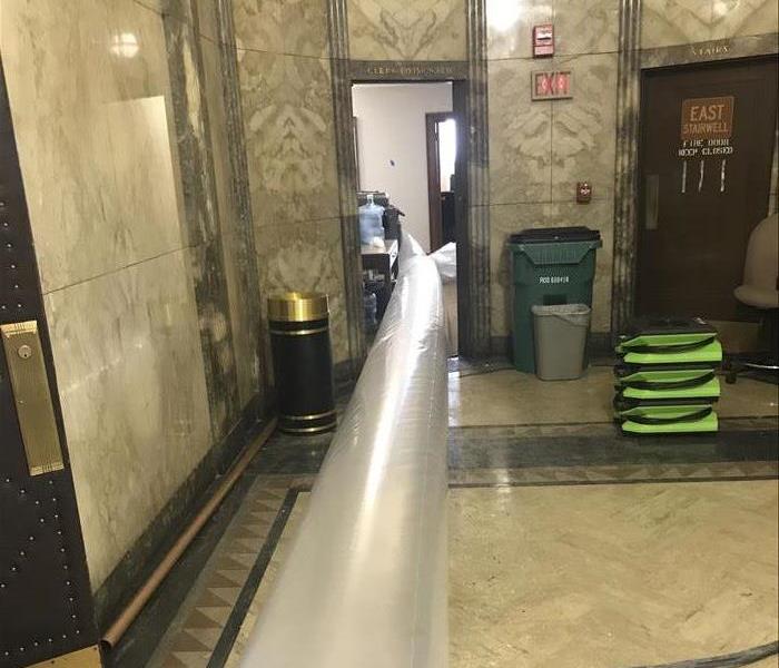 plastic tubing going through a doorway 